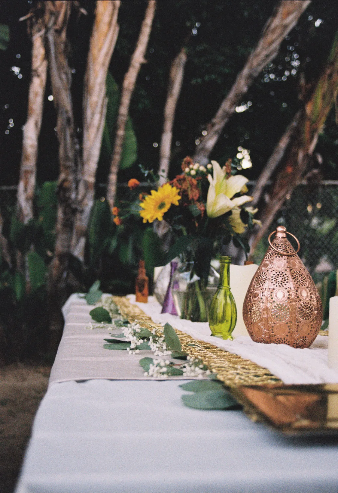 backyard tablescape with lanterns and tablecloth